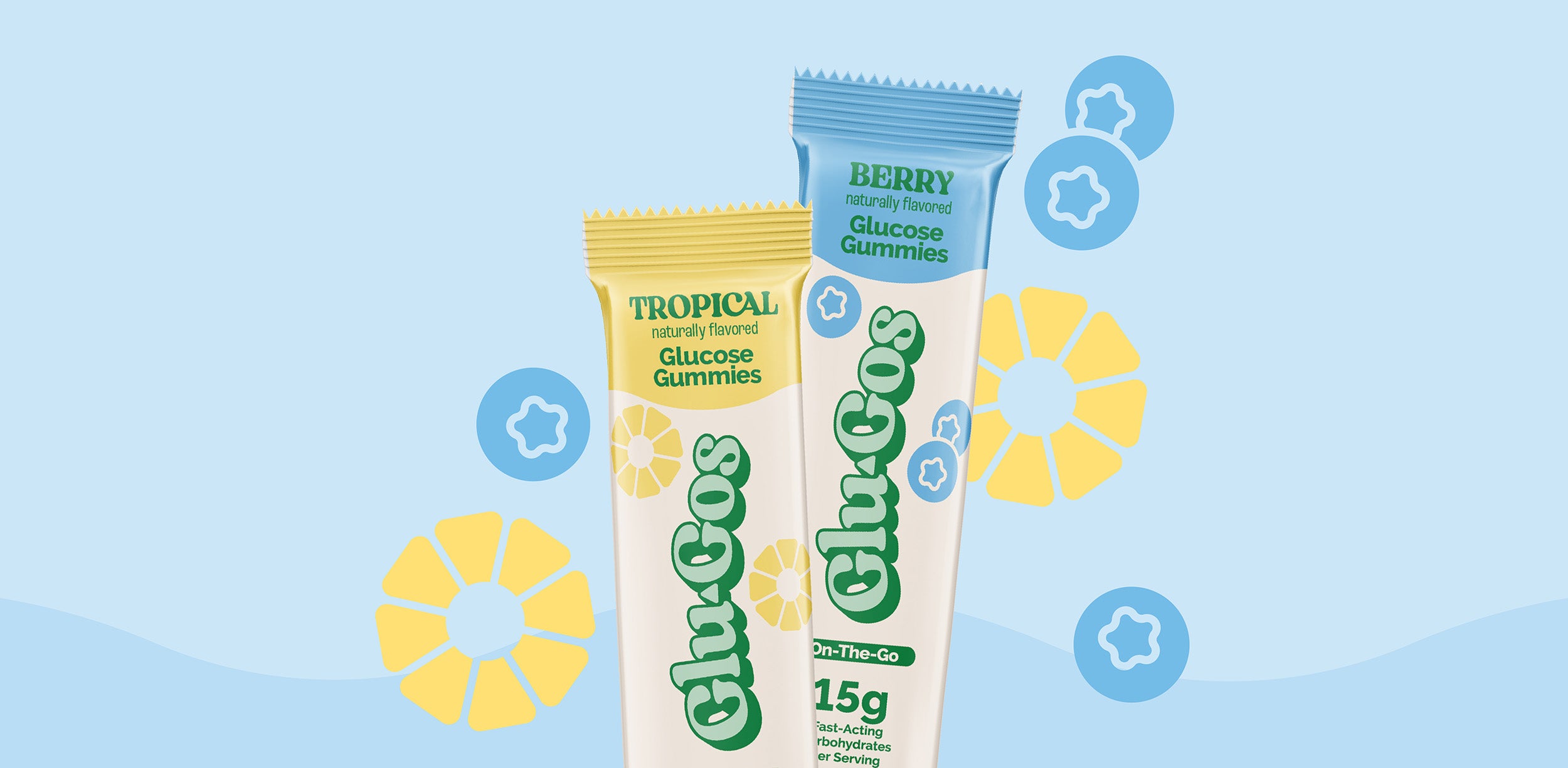 Packages of Glu-Gos Tropical Glucose Gummies (yellow packaging) and Berry Glucose Gummies (blue packaging) on light blue background.